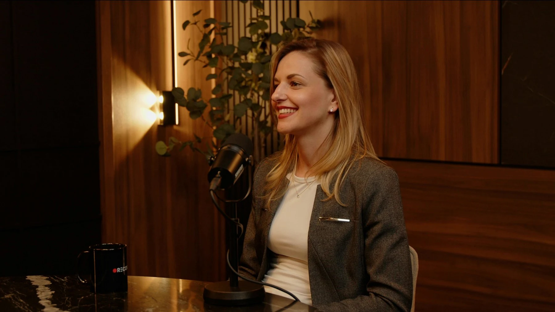 A woman smiles during a recorded interview