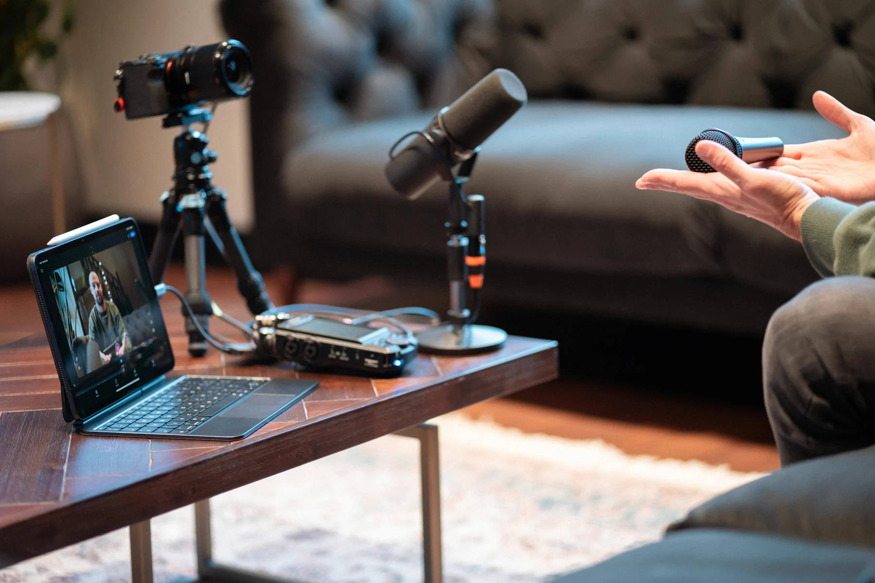 A camera, microphones, and a tablet set up to record a conversation